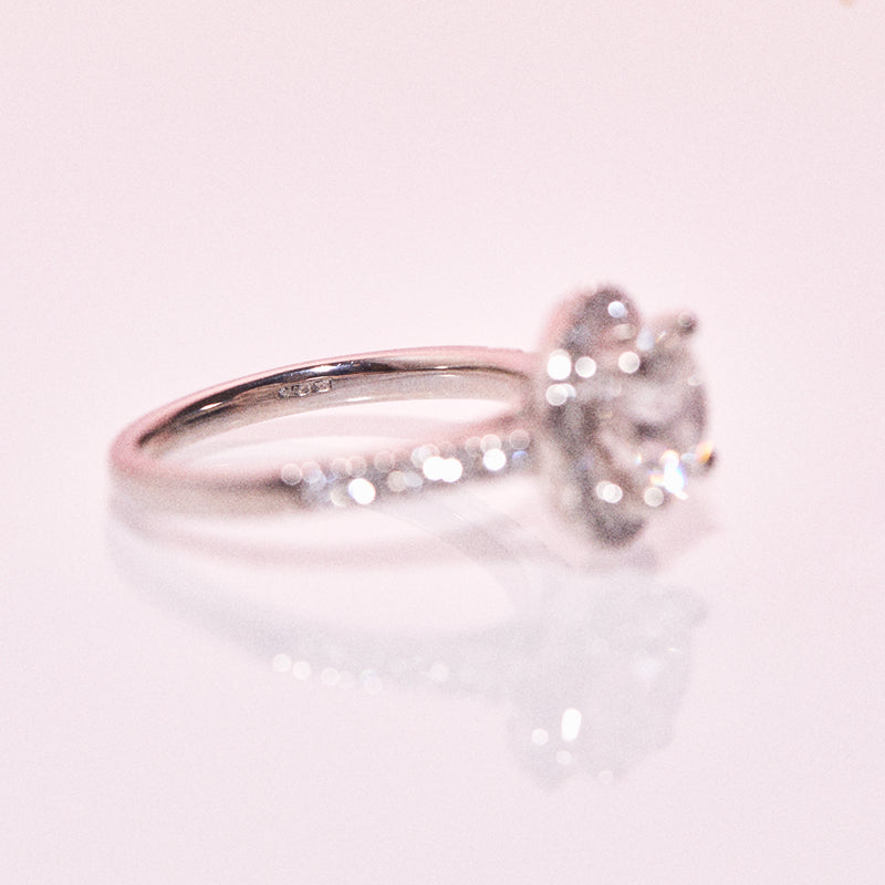 Platinum ring with a central diamond and a diamond halo