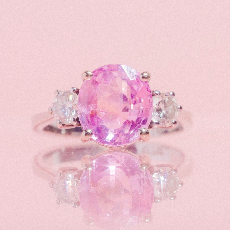 18ct white gold ring set with a pink sapphire and two diamonds