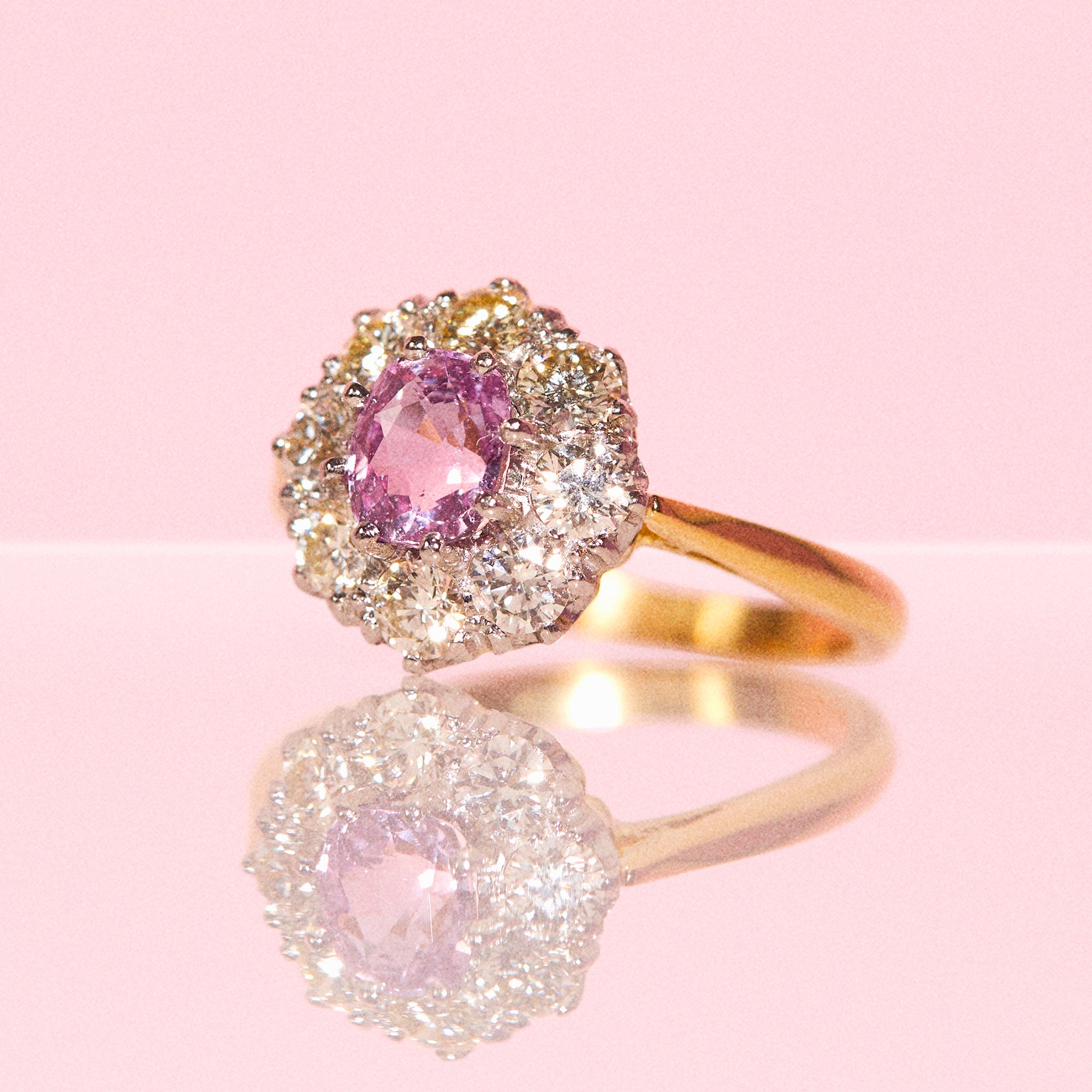 18ct gold ring set with a pink sapphire and diamonds